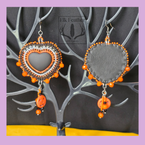 Handmade Harvest Moon Pumpkin Heart earrings featuring Miyuki Delica seed beads, matte black heart cabochons, orange glass bicones, and stone pumpkin charms.